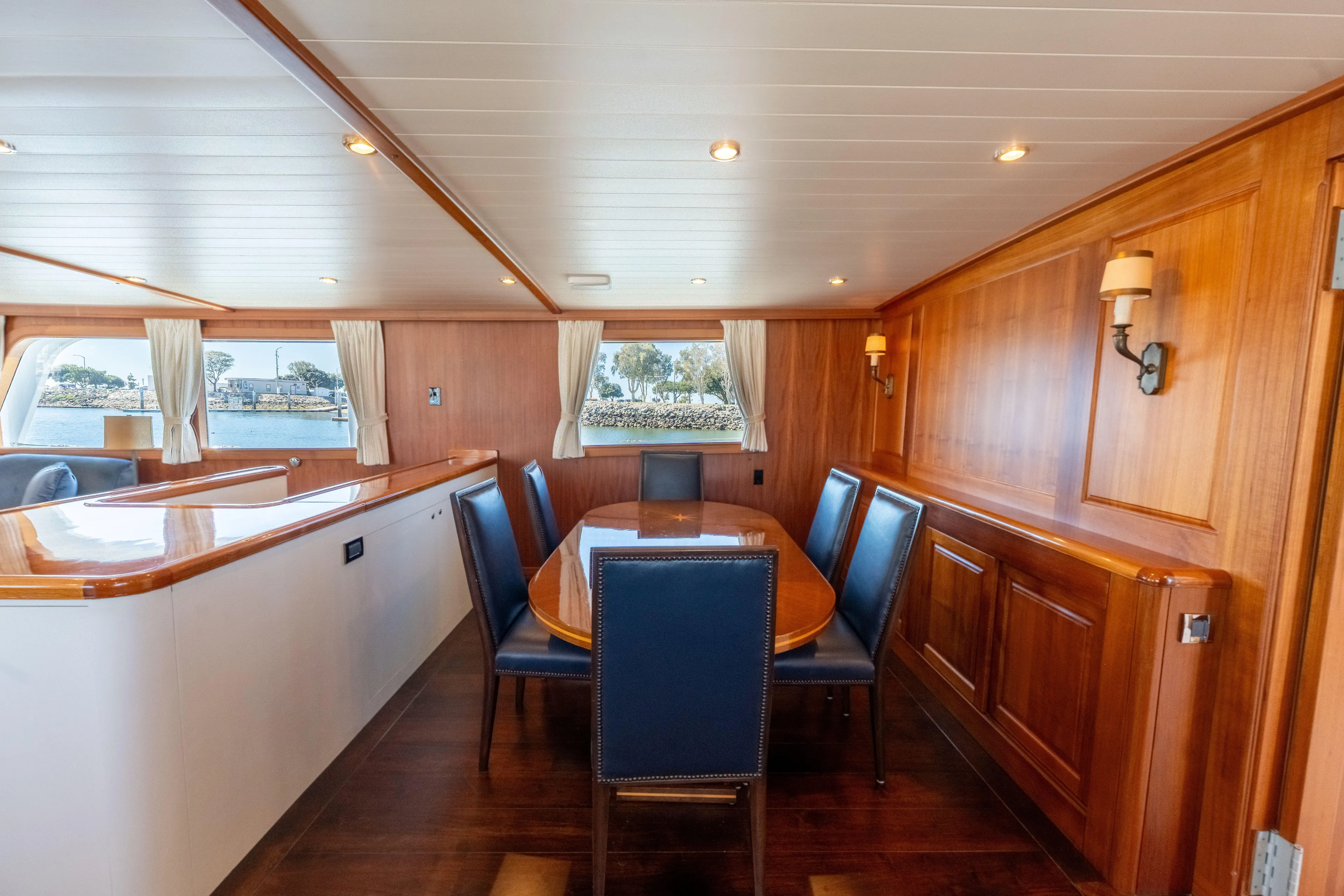 Nordic Star Yacht Photos Pics Luxurious 1969 Custom Hargrave yacht interior with elegant wood paneling and dining area.