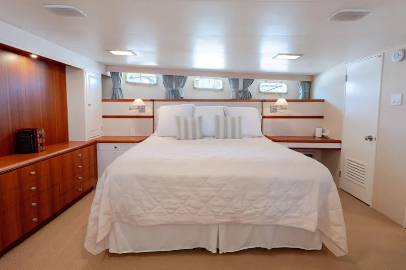 Nordic Star Yacht Photos Pics Luxurious 1969 Custom Hargrave yacht bedroom with elegant wood cabinetry and plush bedding.