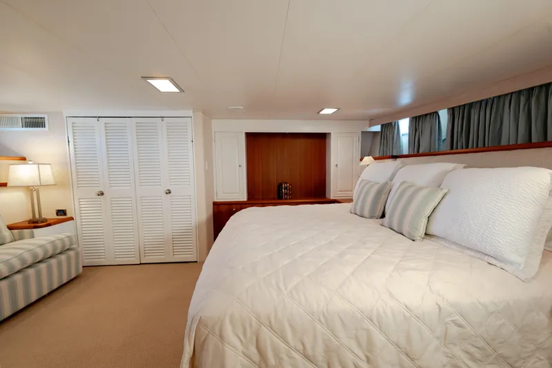 Nordic Star Yacht Photos Pics Luxurious bedroom interior on a 1969 Custom Hargrave yacht, featuring elegant bedding and cozy lighting.
