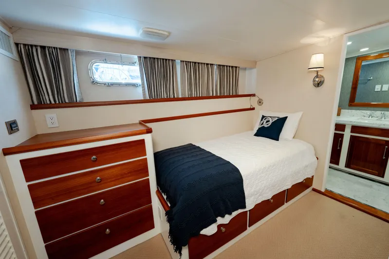 Nordic Star Yacht Photos Pics Cozy 1969 Custom Hargrave yacht cabin with single bed, wooden drawers, and ensuite bathroom.