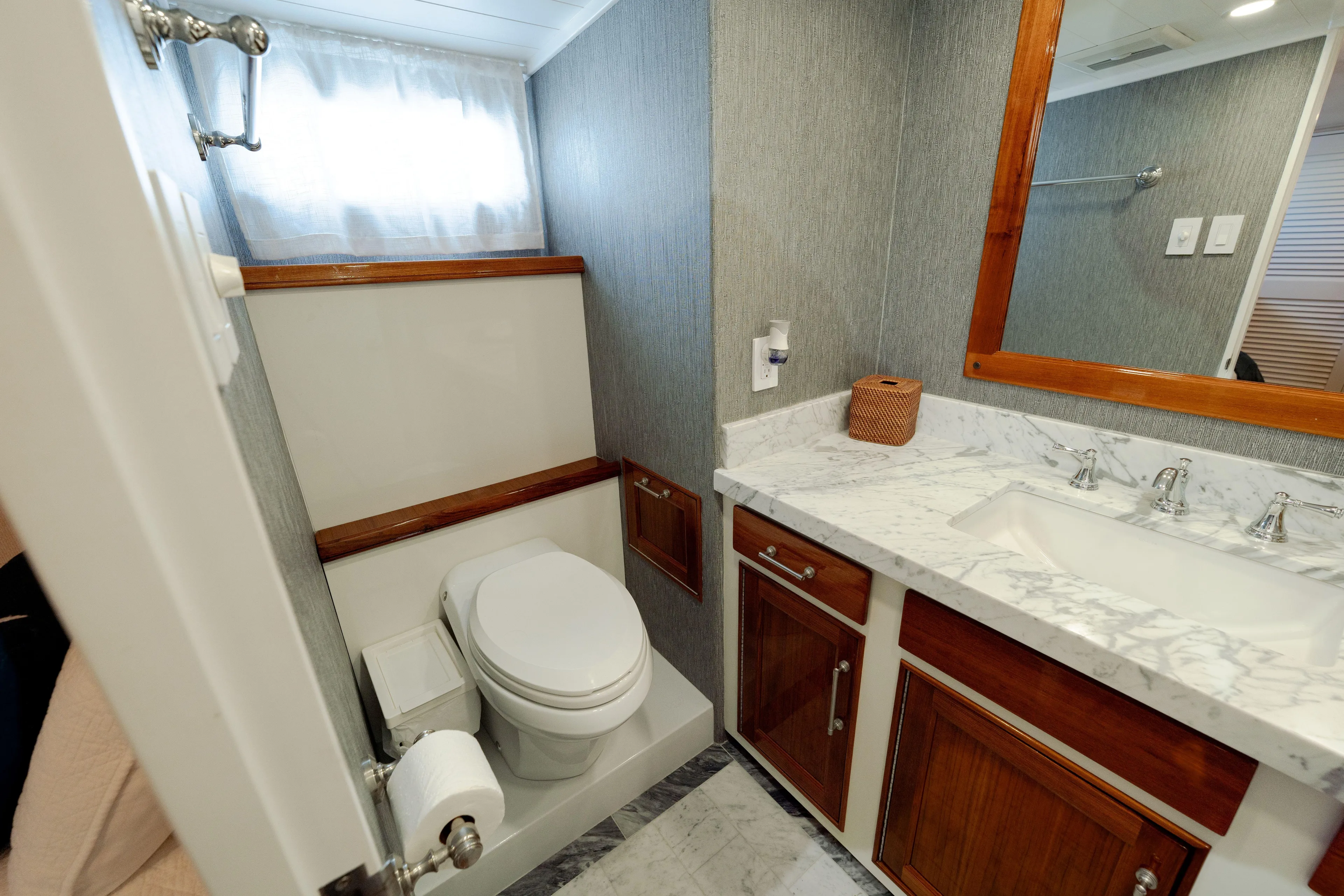 Nordic Star Yacht Photos Pics Luxurious 1969 Custom Hargrave yacht bathroom with marble countertop and wooden accents.