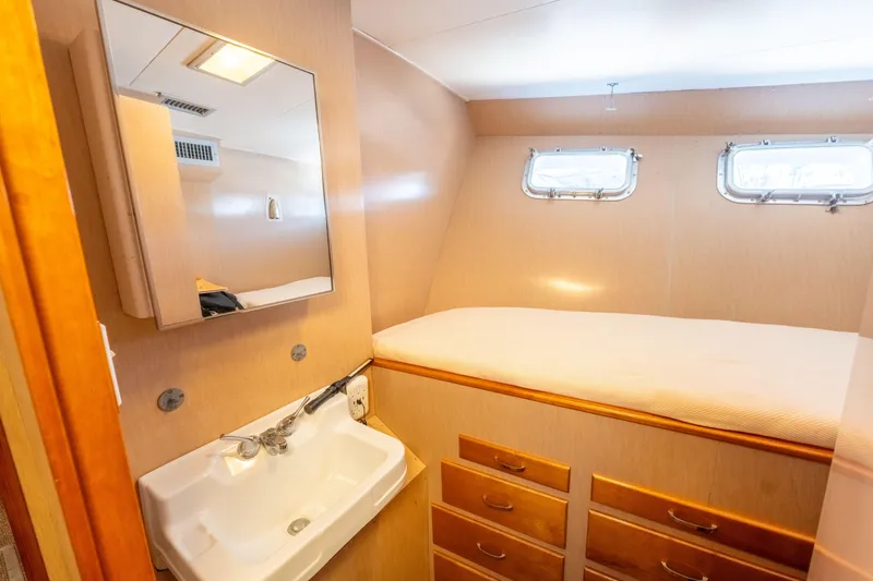 Nordic Star Yacht Photos Pics Cozy cabin interior of 1969 Custom Hargrave yacht with sink, mirror, and bed.