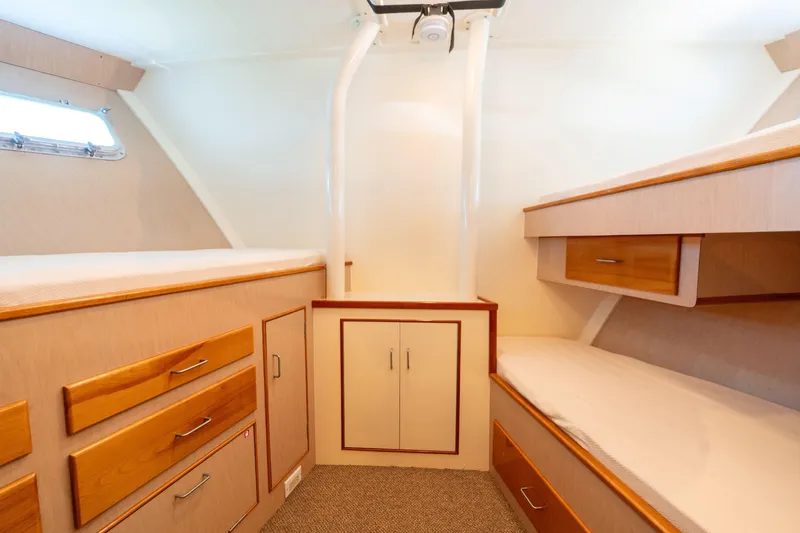 Nordic Star Yacht Photos Pics 1969 Custom Hargrave yacht cabin with wooden drawers, bunk beds, and a porthole window.