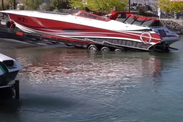  Yacht Photos Pics 2006 Fountain 42 Lightning speedboat being launched into the water from a trailer.