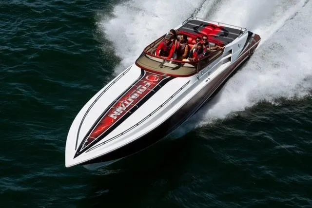  Yacht Photos Pics 2006 Fountain 42 Lightning speedboat cruising on water with passengers.