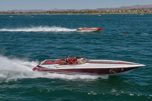  Yacht Photos Pics 2006 Fountain 42 Lightning speedboat racing on open water with another boat in the background.