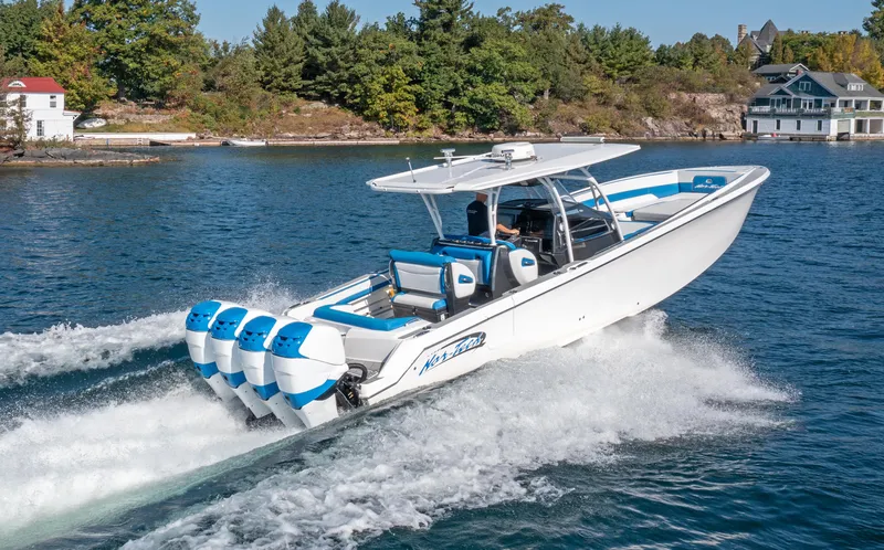  Yacht Photos Pics 2017 Nor-Tech 390 Sport Center Console boat cruising on a scenic lake.