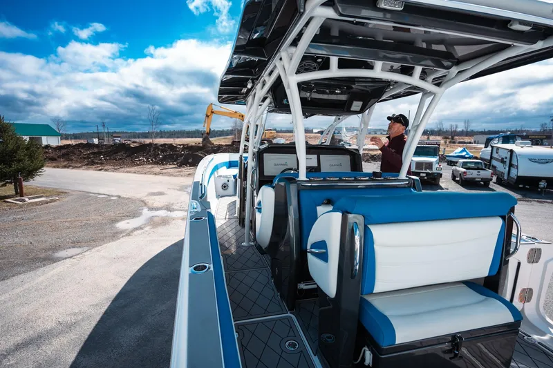  Yacht Photos Pics 2017 Nor-Tech 390 Sport Center Console boat with blue and white seating, parked outdoors.