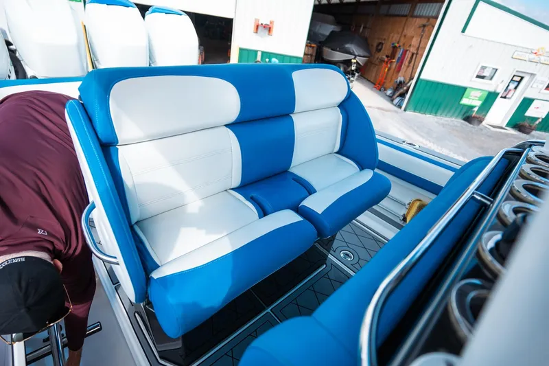  Yacht Photos Pics 2017 Nor-Tech 390 Sport Center Console with blue and white seating in a marina setting.