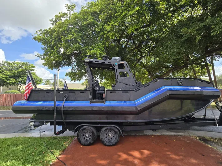 Dgs777 Yacht Photos Pics 2022 DGS 777 Military Version boat on trailer, parked under trees.