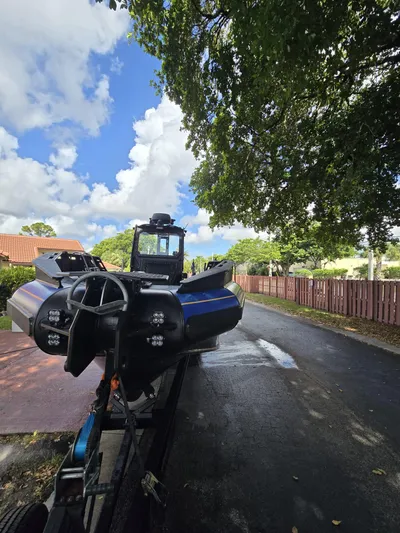 Dgs777 Yacht Photos Pics DGS 777 Military Version 2022 vehicle on trailer under tree-lined street.