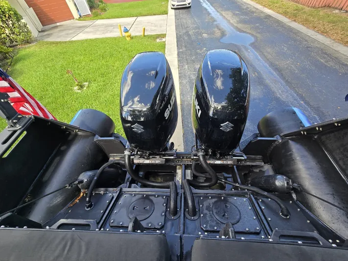 Dgs777 Yacht Photos Pics Twin outboard motors on a 2022 DGS 777 Military Version boat, parked on a street.