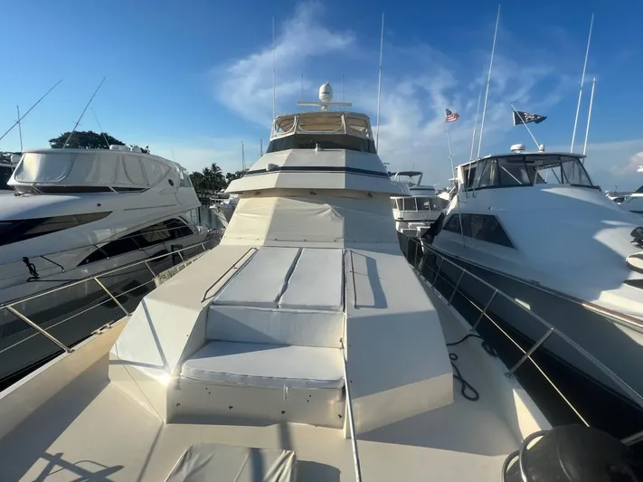 Reflections Yacht Photos Pics 1993 Hatteras 60 ED yacht docked, surrounded by other boats under a clear blue sky.