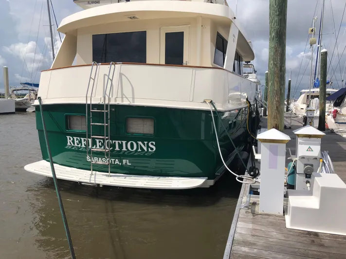 Reflections Yacht Photos Pics 1993 Hatteras 60 ED yacht docked, green hull, named "Reflections," Sarasota, FL.