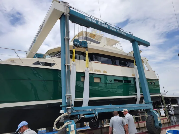 Reflections Yacht Photos Pics 1993 Hatteras 60 ED yacht in boat lift at Snead Island Boat Works.