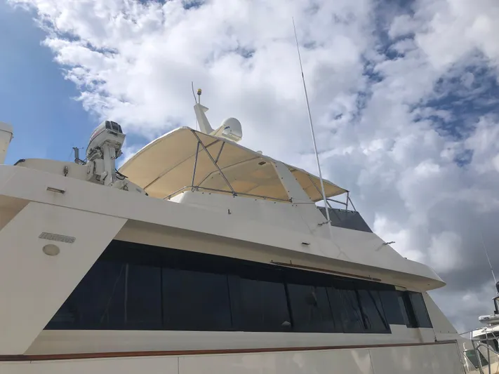 Reflections Yacht Photos Pics 1993 Hatteras 60 ED yacht under cloudy sky, featuring sleek design and modern equipment.