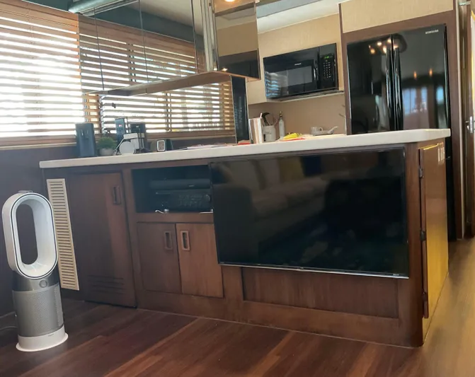 Reflections Yacht Photos Pics Interior of 1993 Hatteras 60 ED yacht with modern kitchen and wooden cabinetry.