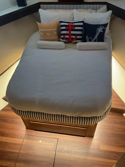 Reflections Yacht Photos Pics Cozy bedroom in 1993 Hatteras 60 ED yacht with nautical-themed pillows.