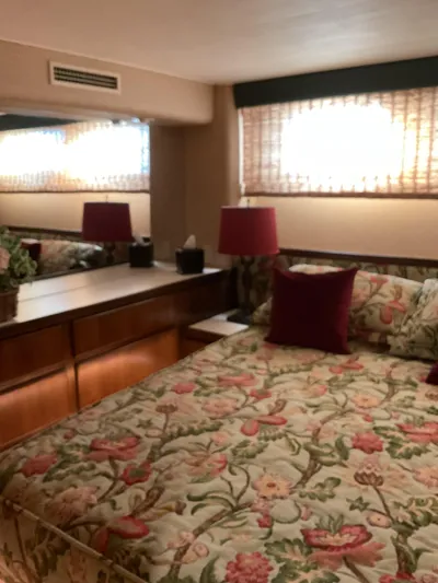 Reflections Yacht Photos Pics Cozy bedroom in 1993 Hatteras 60 ED yacht with floral bedding and red accents.