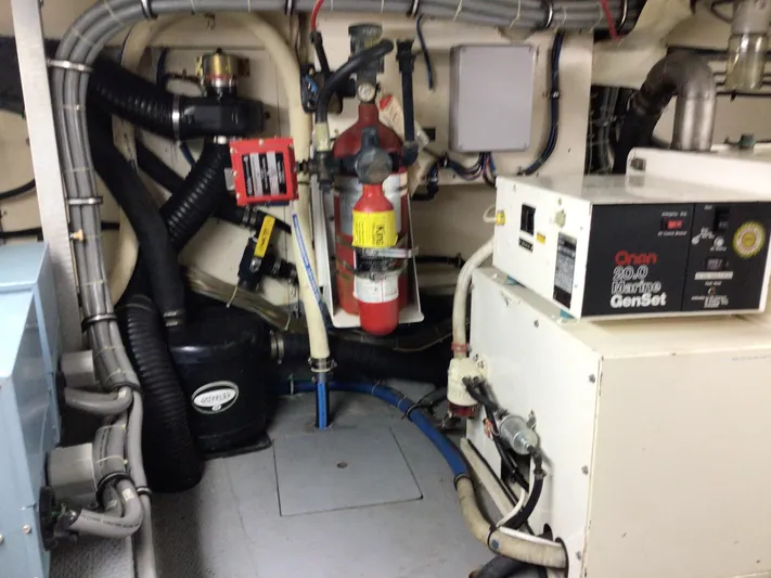 Reflections Yacht Photos Pics Engine room of 1993 Hatteras 60 ED yacht with Onan marine generator and fire extinguisher.
