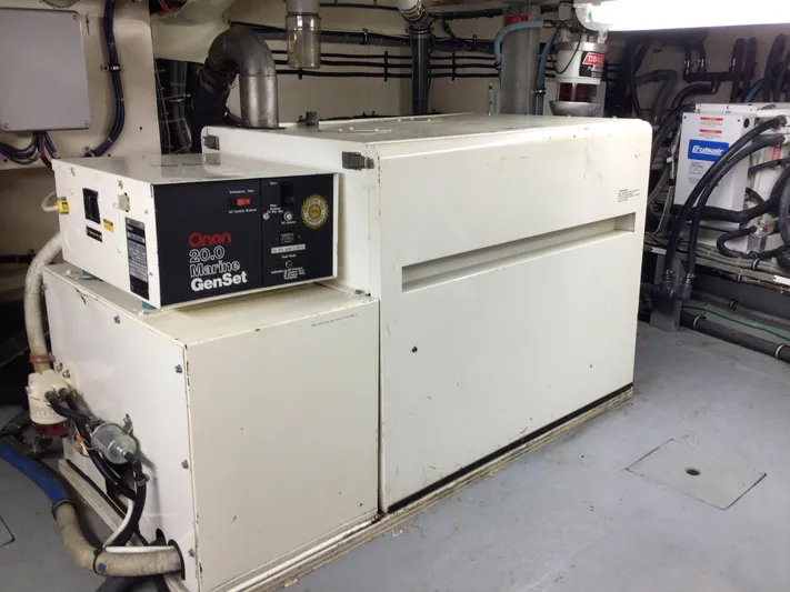 Reflections Yacht Photos Pics Engine room of 1993 Hatteras 60 ED with Onan 20.0 Marine GenSet.