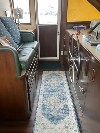 Reflections Yacht Photos Pics Interior of 1993 Hatteras 60 ED yacht with helm, seating, and nautical decor.