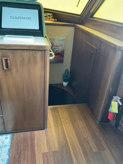 Reflections Yacht Photos Pics Interior of 1993 Hatteras 60 ED yacht with Garmin display and wooden flooring.