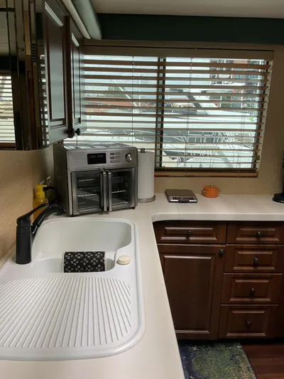 Reflections Yacht Photos Pics Kitchen area of a 1993 Hatteras 60 ED yacht with sink and appliances.