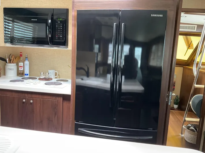 Reflections Yacht Photos Pics Kitchen interior of 1993 Hatteras 60 ED yacht with modern appliances.