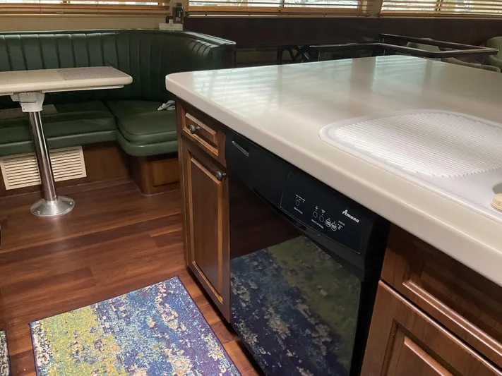 Reflections Yacht Photos Pics Interior of 1993 Hatteras 60 ED yacht with kitchen and dining area.