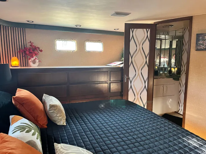 Reflections Yacht Photos Pics Luxurious bedroom interior of 1993 Hatteras 60 ED yacht with modern decor and ensuite bathroom.