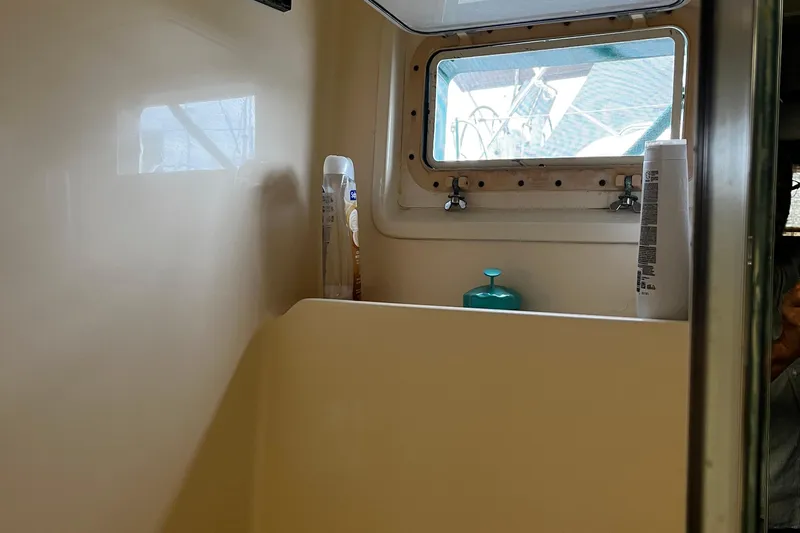 Reflections Yacht Photos Pics Interior of 1993 Hatteras 60 ED yacht bathroom with toiletries and window.