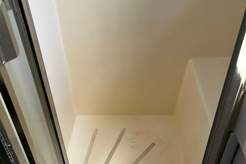 Reflections Yacht Photos Pics Interior of a 1993 Hatteras 60 ED yacht, featuring a clean, white compartment.