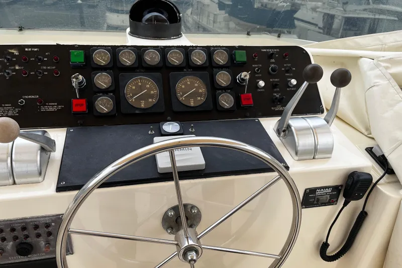 Reflections Yacht Photos Pics Control panel of a 1993 Hatteras 60 ED yacht with steering wheel and gauges.