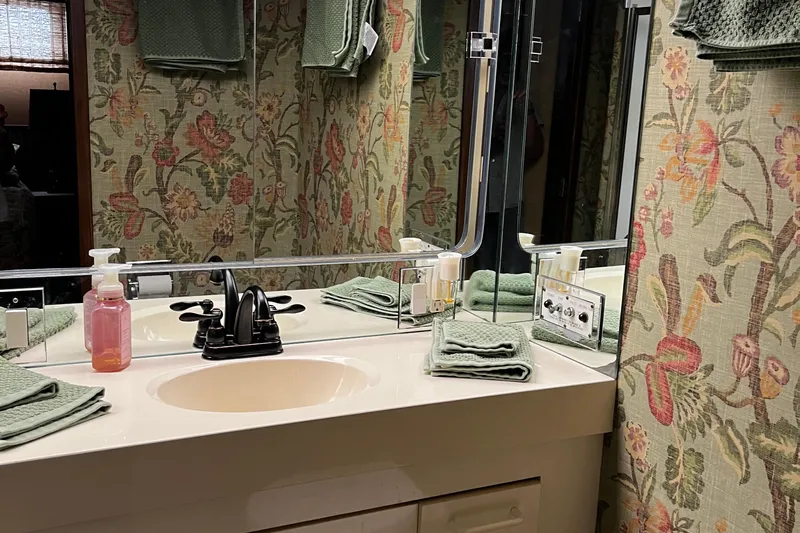 Reflections Yacht Photos Pics Bathroom vanity with floral wallpaper in a 1993 Hatteras 60 ED yacht.