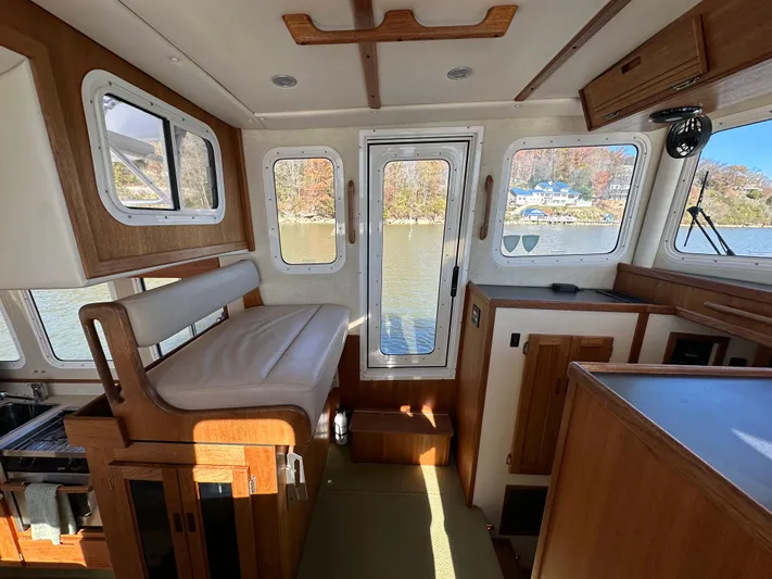  Yacht Photos Pics Interior of 2007 Nordic Tug 32 with wood accents and large windows.