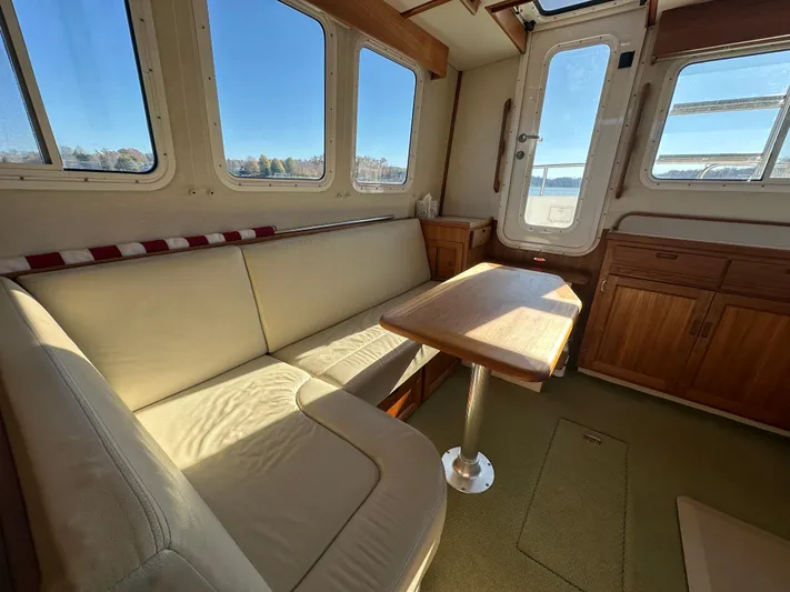  Yacht Photos Pics Cozy interior of 2007 Nordic Tug 32 with seating and table.