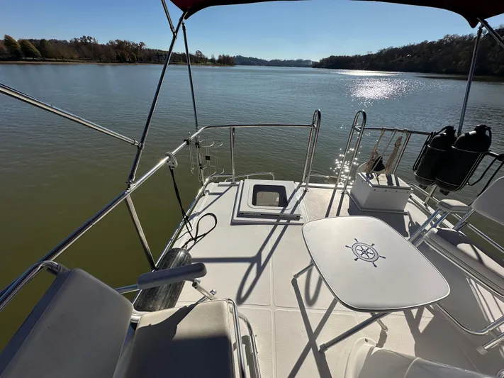  Yacht Photos Pics 2007 Nordic Tug 32 boat deck with seating, table, and scenic water view.
