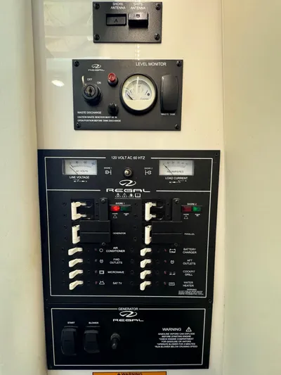 Mullin' It Over Again Yacht Photos Pics Electrical control panel of a 2019 Regal 33 SAV boat with level monitor.