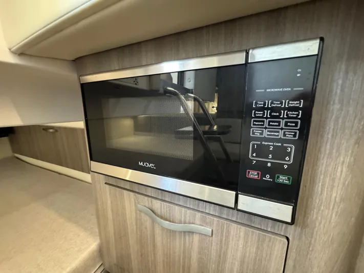Mullin' It Over Again Yacht Photos Pics Built-in microwave in 2019 Regal 33 SAV boat interior.