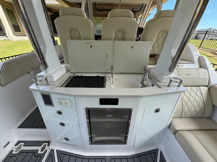 Mullin' It Over Again Yacht Photos Pics 2019 Regal 33 SAV boat interior with kitchenette and seating area.