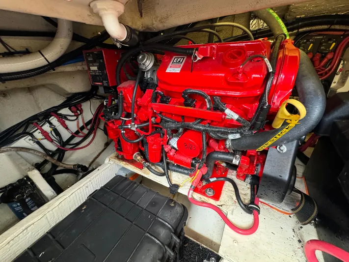 Mullin' It Over Again Yacht Photos Pics Engine compartment of a 2019 Regal 33 SAV boat, featuring a red EFI engine.