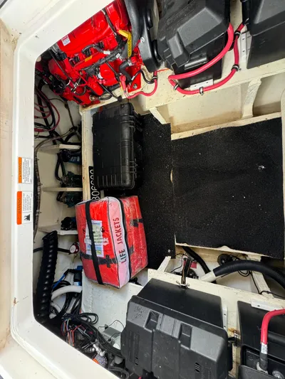Mullin' It Over Again Yacht Photos Pics 2019 Regal 33 SAV boat storage compartment with life jackets and battery setup.