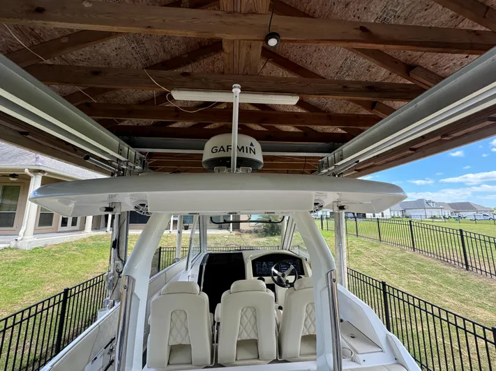 Mullin' It Over Again Yacht Photos Pics 2019 Regal 33 SAV boat under wooden shelter with Garmin equipment.
