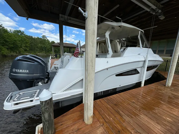 Mullin' It Over Again Yacht Photos Pics 2019 Regal 33 SAV boat docked with Yamaha outboard motor, under a covered pier.