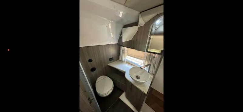 Mullin' It Over Again Yacht Photos Pics 2019 Regal 33 SAV bathroom interior with modern fixtures and compact design.