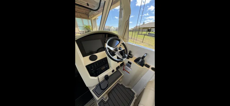 Mullin' It Over Again Yacht Photos Pics 2019 Regal 33 SAV boat helm with steering wheel and control panel.