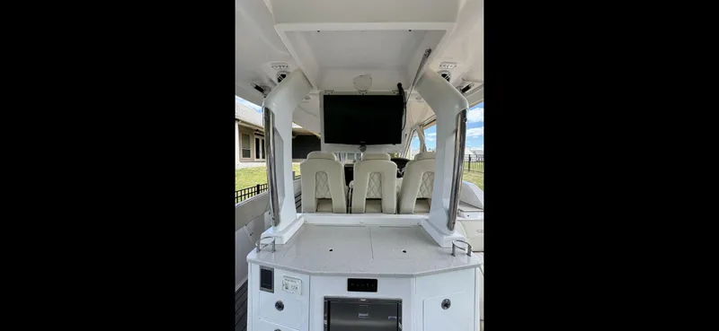 Mullin' It Over Again Yacht Photos Pics 2019 Regal 33 SAV boat interior with seating and mounted TV.