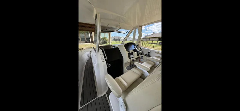Mullin' It Over Again Yacht Photos Pics 2019 Regal 33 SAV boat cockpit with modern controls and comfortable seating.