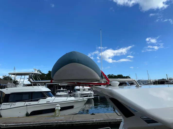  Yacht Photos Pics 2025 Aquila 36 Sport yacht docked at marina under clear blue sky.